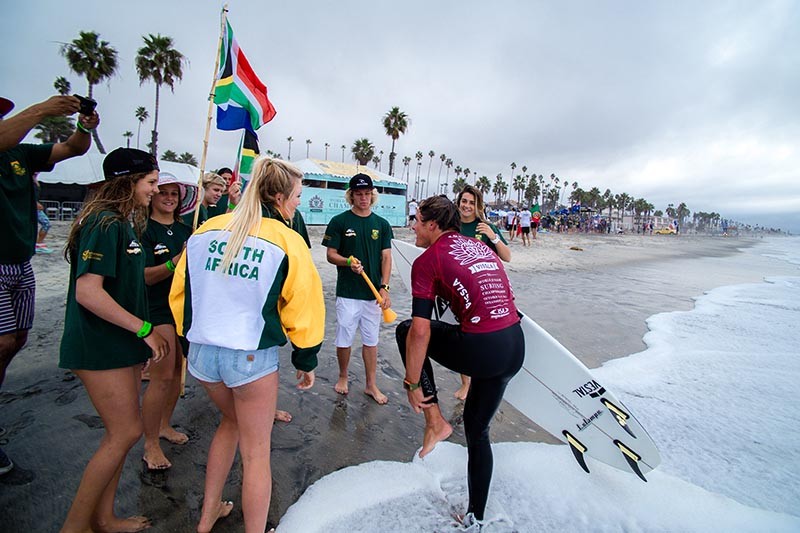 SA junior team members congratulate their captain, Shane Sykes, after progressing to the next round. Photo: ISA/Chris Grant
