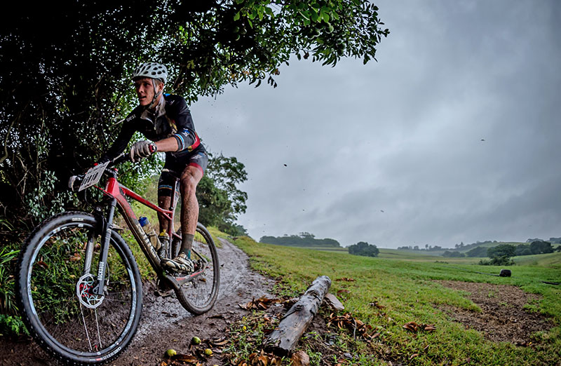 A wet and muddy Matt Wilkinson negotiates a stretch of single track. Photo: Em Gatland