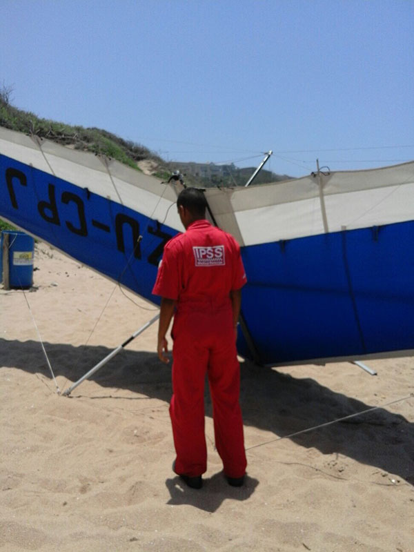 A paramedic standing at the microlight on the beach. Photo: IPSS Medical Rescue