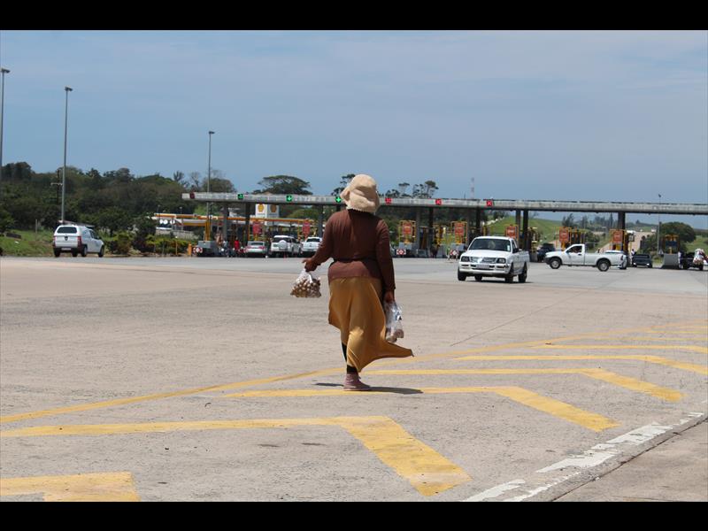 Hloniphile Gumede waiting for a customer to drive past.