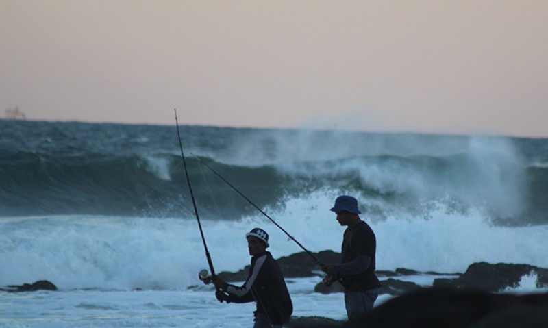 Two local fishermen going for shad at sunrise on Tiffany's beach in Salt Rock.