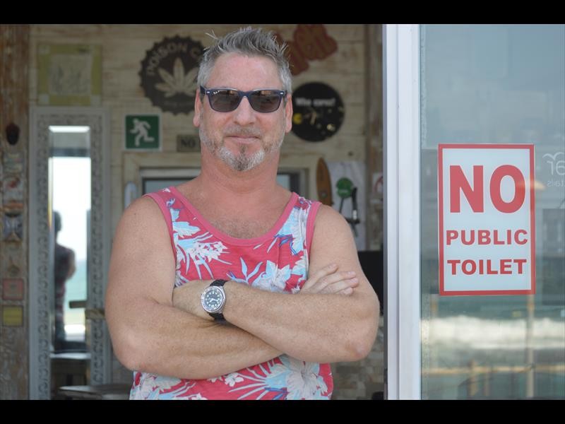 Leonard Staples at the SandBar, where he had to put up a "no public toilet" sign, as beachgoers have no ablution blocks and he has no water.