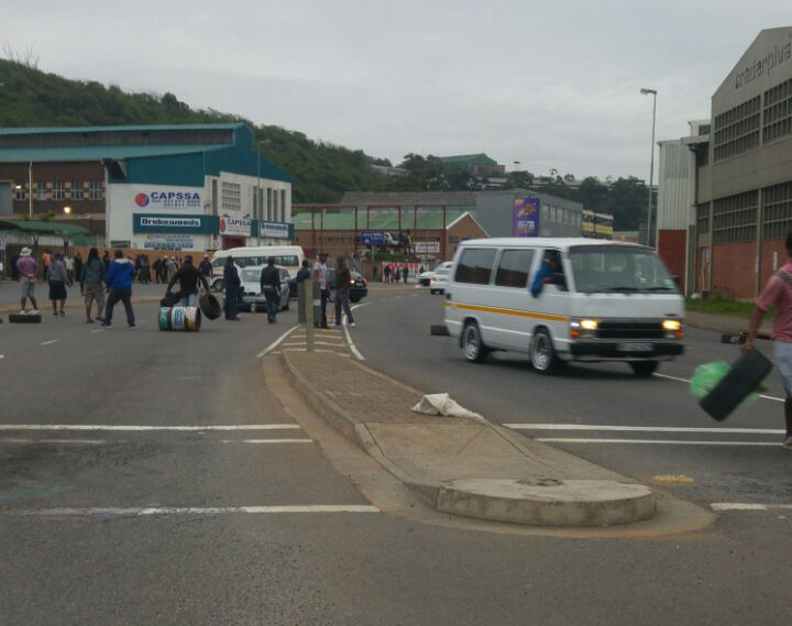 Taxi drivers have blocked the roads with dust bins and burning debris.