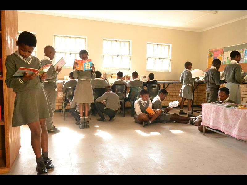The school library is a busy place despite outdated books and sparse furniture