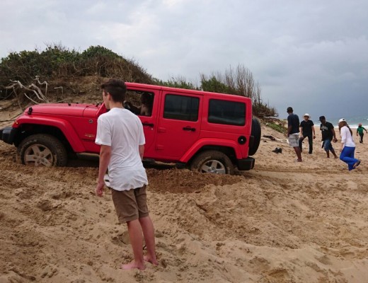 Locals banded together to get the Jeep out of the water and off the beach. Photo: Specialised Rescue