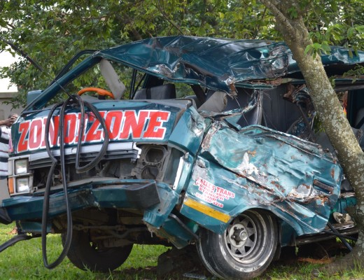 The mangled wreck of a taxi in which two people died this morning.