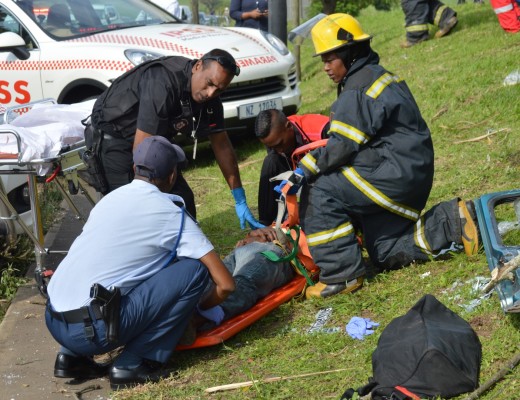SAPS and emergency personnel stabilise a man after a taxi crash on the R102. 