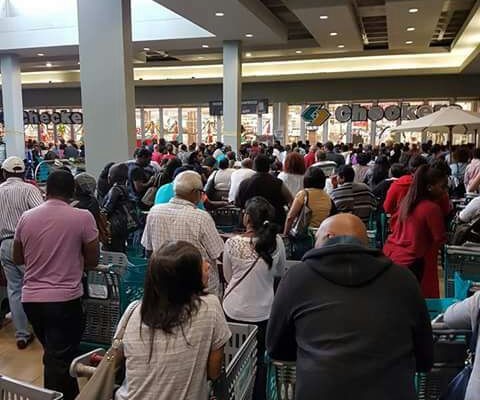 Shoppers wait outside Checkers Ballito before the store opened this morning.
