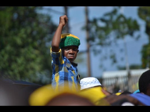 A young ANC supporter salutes Zuma at the ANC's 105th birthday anniversary celebration.