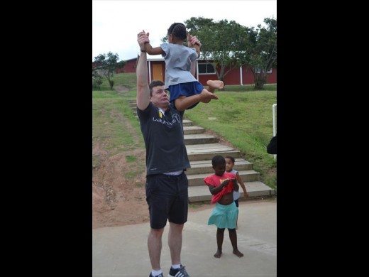 Rugby legend Brian O'Driscoll having some fun with one of LIV Village's children.