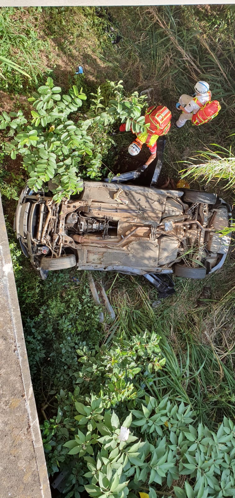 The vehicle landed on its roof, trapping two people inside.