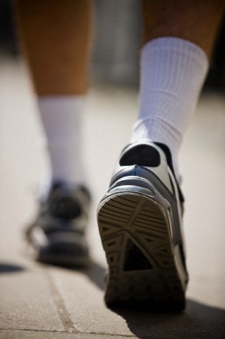 Young man jogging in trainers, rear view