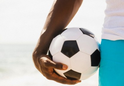 Mixed race man holding soccer ball