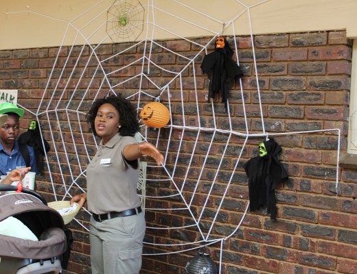 Pretoria Zoo staff member ushering people inside the Pretoria Zoo.