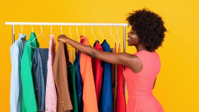 Happy,African,American,Woman,Shopping,In,Store,Choosing,New,Outfit