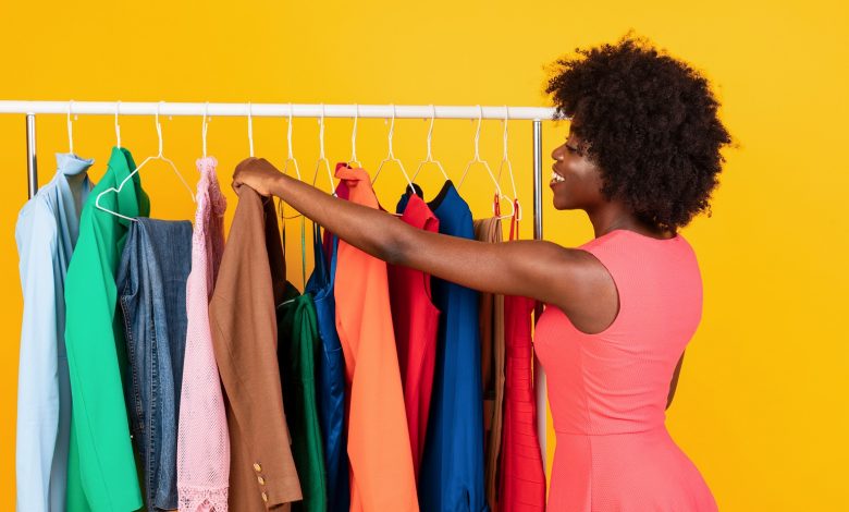 Happy,African,American,Woman,Shopping,In,Store,Choosing,New,Outfit