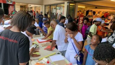Volunteers hard at work covering books at the Back to school campaign.