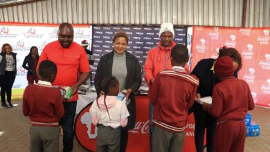 Learners from Mononong primary school receive warm winter jerseys.