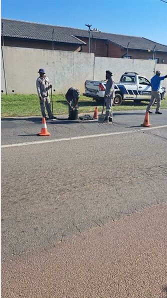 Residents, ward councillor and business patch potholes in Silverlakes Road