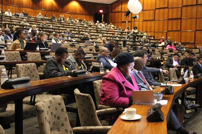 A large group of people sitting in a lecture hall.