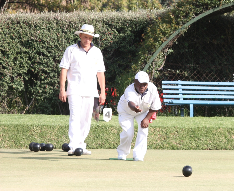 Frans van Wyk looking on as his rival Robert Ramuthivheli delivers, on the green at Roosevelt Park Bowls Club.