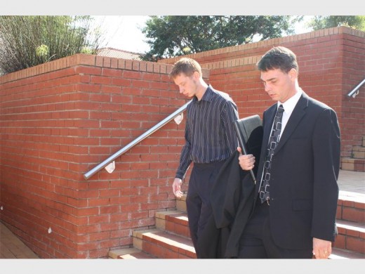 The accused (left) is charged with assault with intent to do grievous bodily harm. On the right is his legal representative.