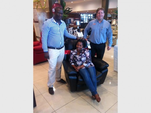 Polite Ngubeni at the Rochester furniture store with her new chair.