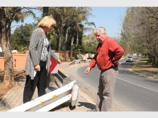 Ward 98 councillor Laurette van Zijl and Barry Werner check the unpainted street barriers on Monkor Drive.
