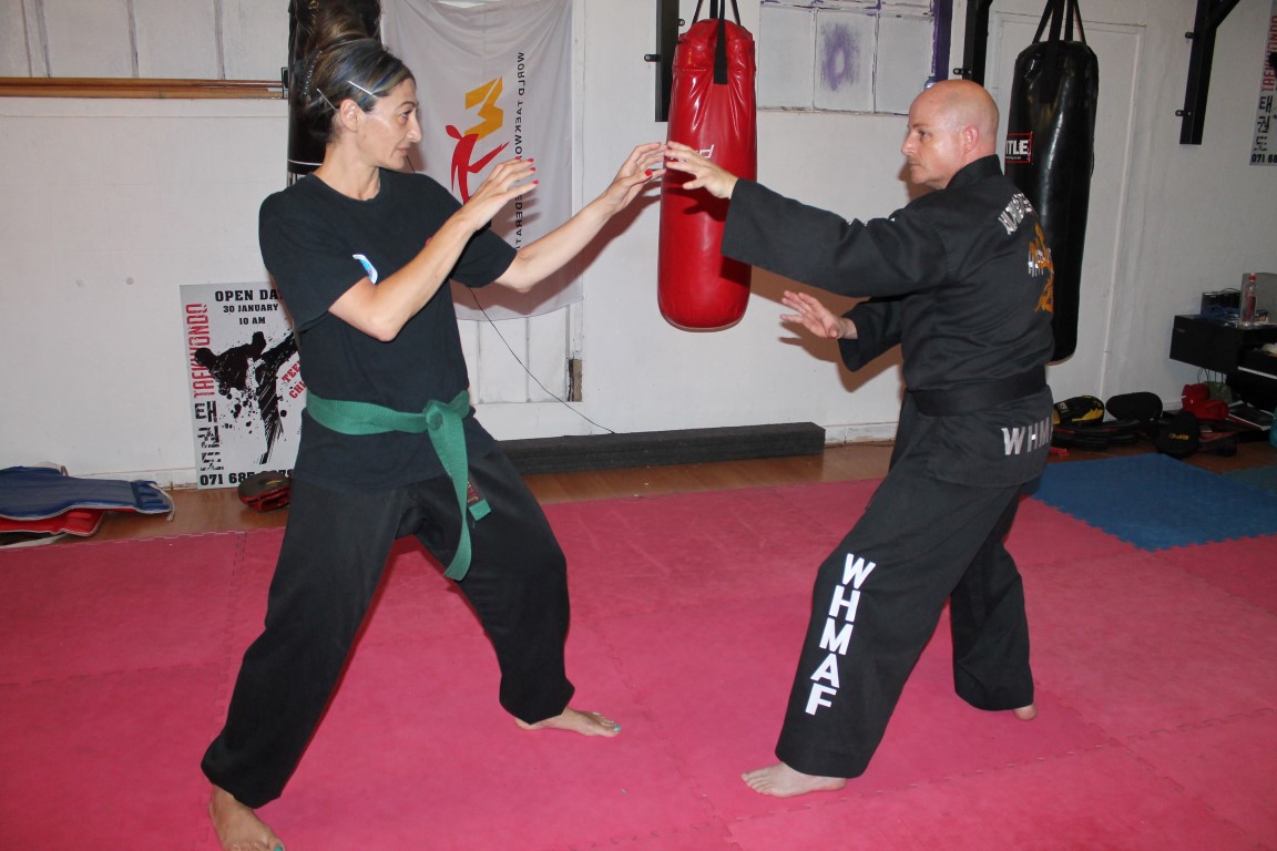 Kelly Dairopoulos and instructor, Philip Wadsworth, practise their hapkido moves.