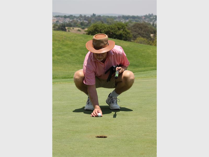 Steve Hulse prepares for a putt at one of the holes.