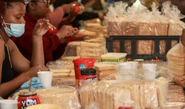 Loaves of bread, and tubs of peanut butter and jam line the tables. Photo: Neo Phashe