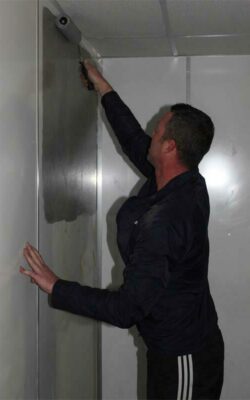 Anthony Beer starts to paint one of the walls at the station.