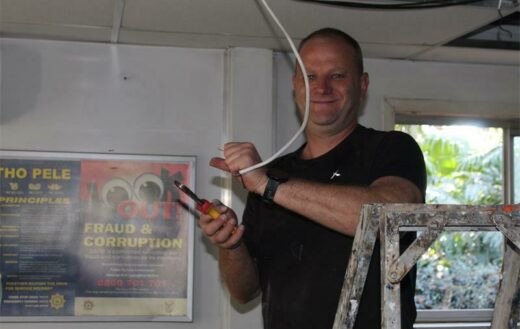 Dean Clark helps to rewire a light.