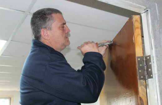 Wayne Tippett fixes a door at the station.