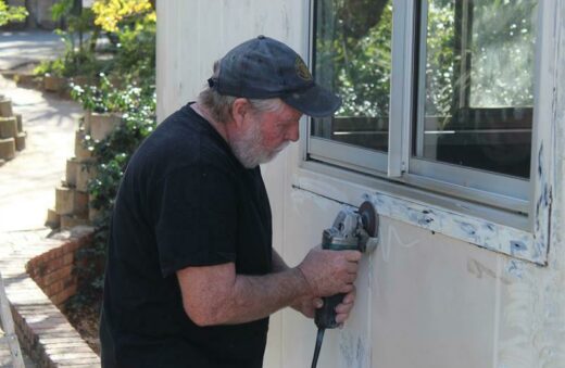 Rodney Parkin angle grinds one of the police station's windows.