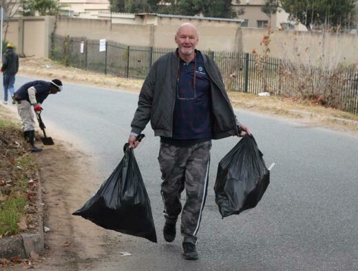 Leonard Smith collects rubbish for removal. Photo: Nicholas Zaal