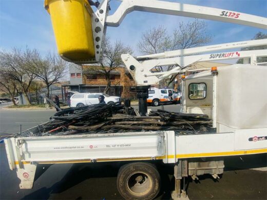 Electrical cables that were used for illegal connections to supply the informal settlement with power are put inside the crane truck. Photo: Simon Majadibodu