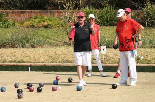 Chairperson of bowls at Old Parks, Bill Bowen indicates to a teammate how far their bowl is to the pin. Photo: Nicholas Zaal