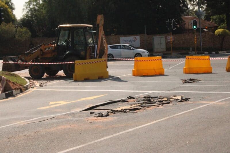 A ruptured 800mm water main has torn through the surface of Jacaranda Avenue in Olivedale, leaving the road closed and badly damaged for nearly a week.