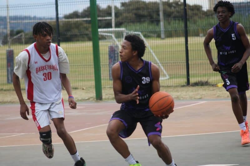 Wild Dogs' Handsome Vazi looks to make a play under pressure from King Solomon Basketball Academy's Leago Mothupi during their friendly match at Randburg Sports Complex. Photo: Nkazimulo Ncube