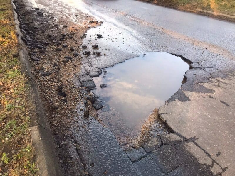 The months-neglected pipe burst on Long Avenue has created deep potholes on Rocky Street in Ferndale. Photo: Mthulisi Lwazi Khuboni