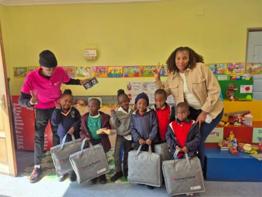 Foundation phase learners proudly hold their newly donated blankets from HomeChoice inside their bright, revitalised classroom. Photo: Supplied