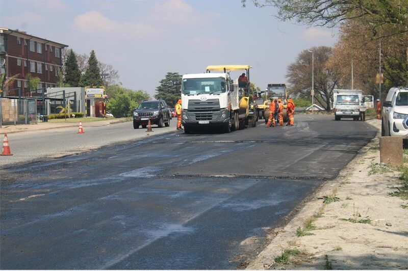 After contractual disputes halted maintenance on a dug-up section of the busy thoroughfare, leaving motorists to navigate potholes and lose gravel, work has recommenced.