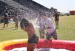 Students get soaked by water spraying over an inflatable paddling pool during outdoor games at the spring day event. Photo: Nkazimulo Ncube