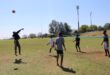 A group of students play volleyball on the grass at the Randburg Sports Complex, with inflatable attractions visible in the background. Photo: Nkazimulo Ncube