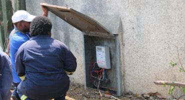 City Power officials check the wiring and metering of an electricity connection at a property in Ferndale, one of several checks carried out during the September 17 multi-agency operation in Ward 102. Photo: Nkazimulo Ncube