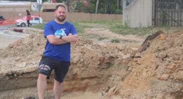 Ward 134 councillor Devon Steenkamp on Puttick Avenue that is currently closed as contractors dug up the road to fix the pipe. Photo: Mthulisi Lwazi Khuboni