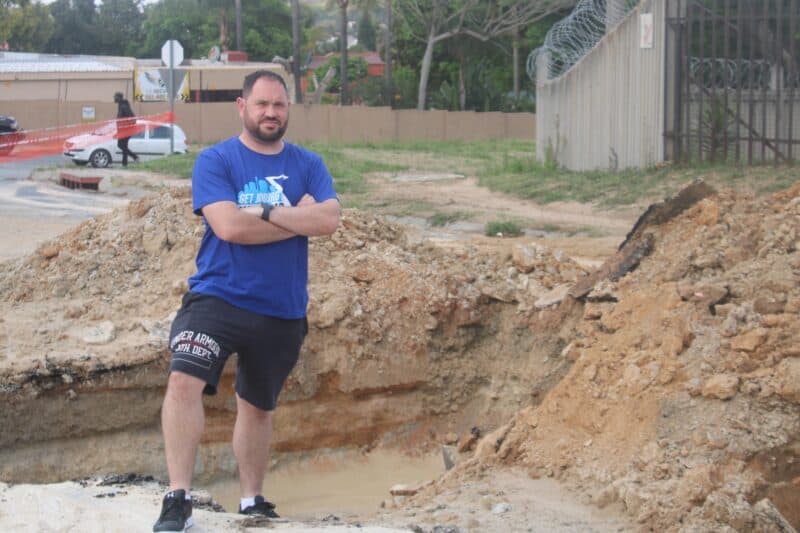 Ward 134 councillor Devon Steenkamp on Puttick Avenue that is currently closed as contractors dug up the road to fix the pipe. Photo: Mthulisi Lwazi Khuboni