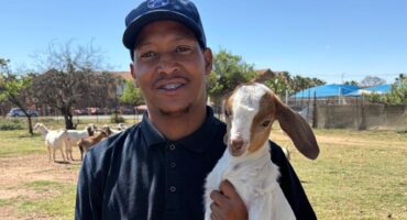 Molefe Mosenogi from Randburg SPCA and one of their adorable kid goats encourages you to choose Randburg SPCA and stand a stand to win R50 000. Photo: Supplied