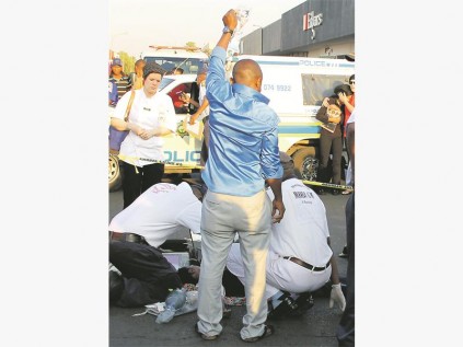 Ms Joanne Petzer looks on as paramedics try to resussitate Mapule Serepo.
